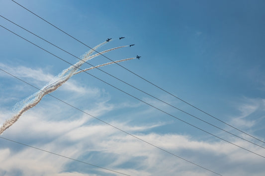 a group of planes fly through the air