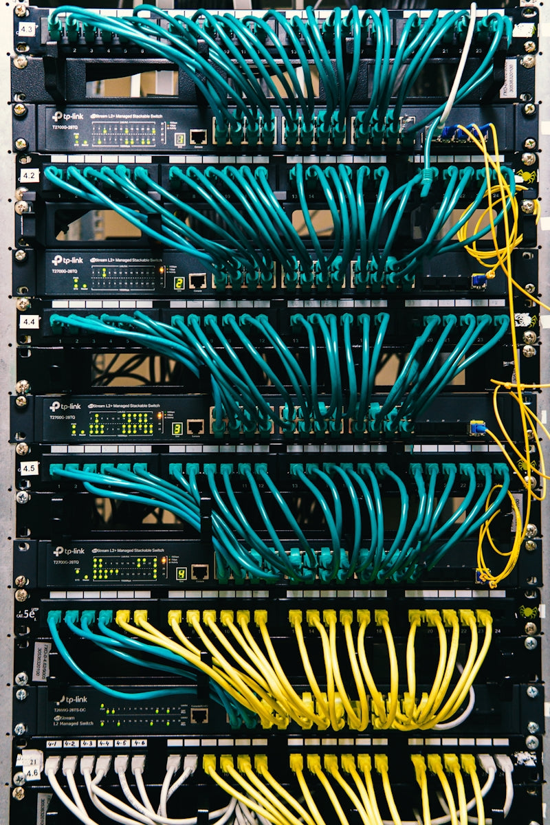 a rack of servers with wires and wires attached to them