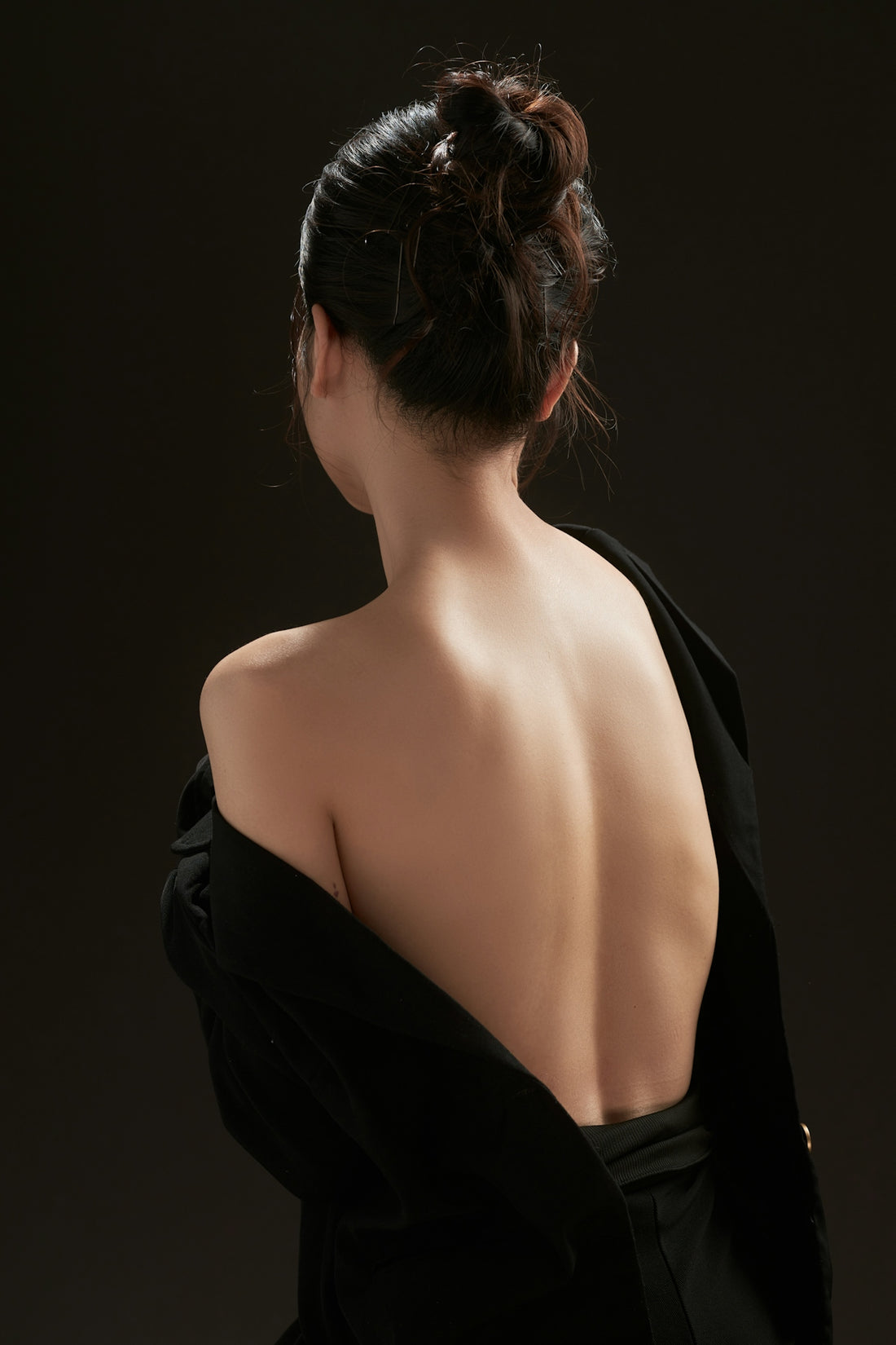 The back of a woman in a black dress