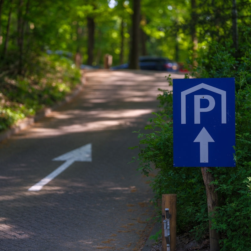 Parking sign points to parking area.