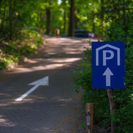 Parking sign points to parking area.