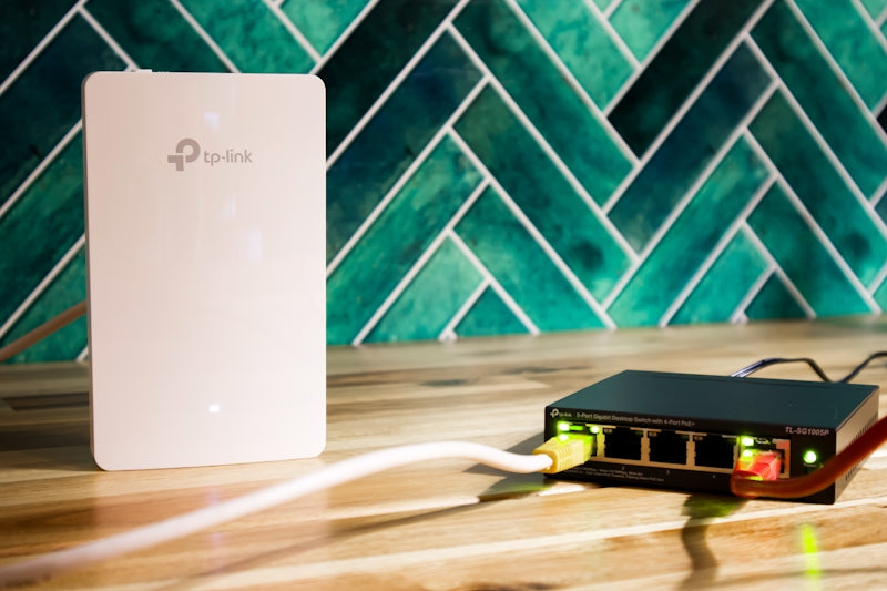 A wi-fi router and a network switch sit side-by-side.