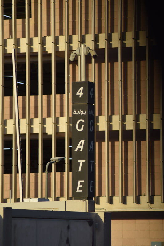 Gate 4 sign with security cameras